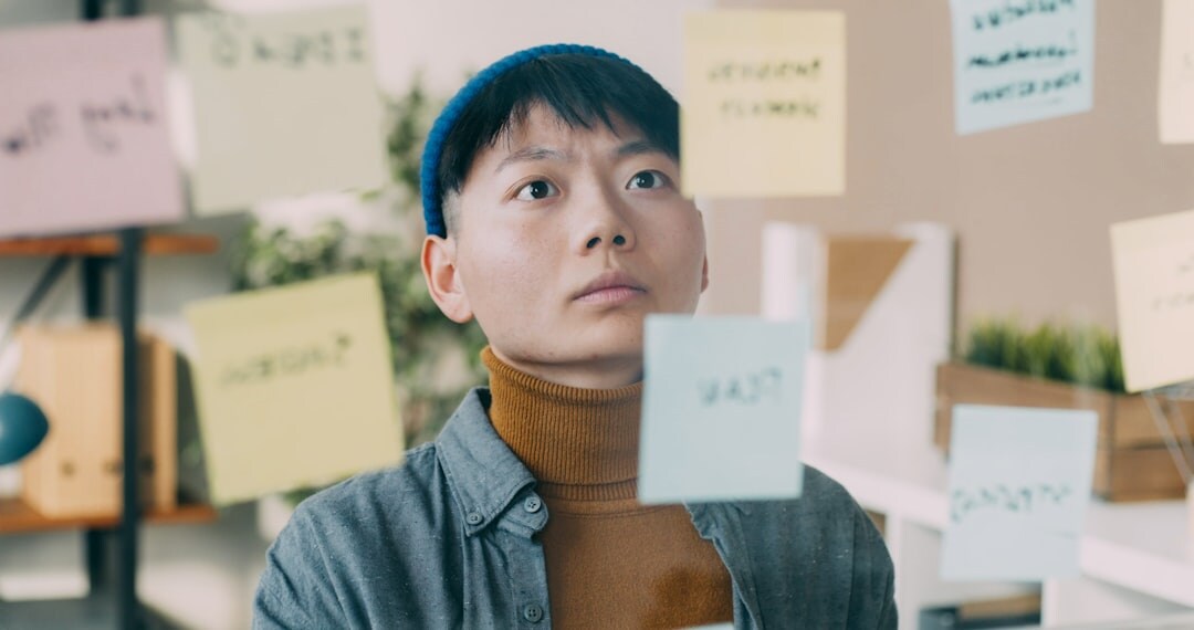 man reflecting on notes