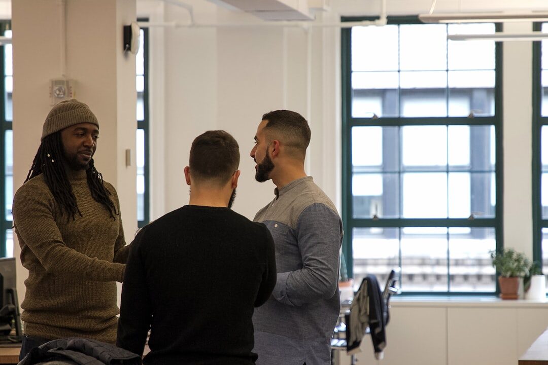 Two Brazilian colleagues having a warm, engaged conversation in a bright office