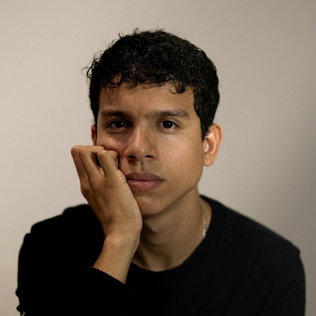 Studio portrait of a smiling young Brazilian man with short hair