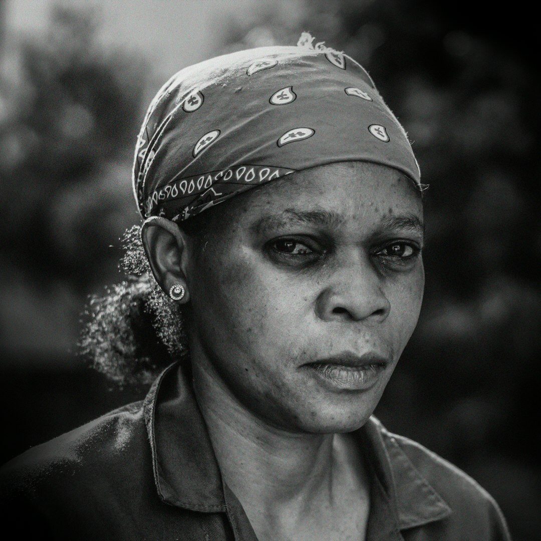 Studio portrait of a smiling older Brazilian woman with grey hair
